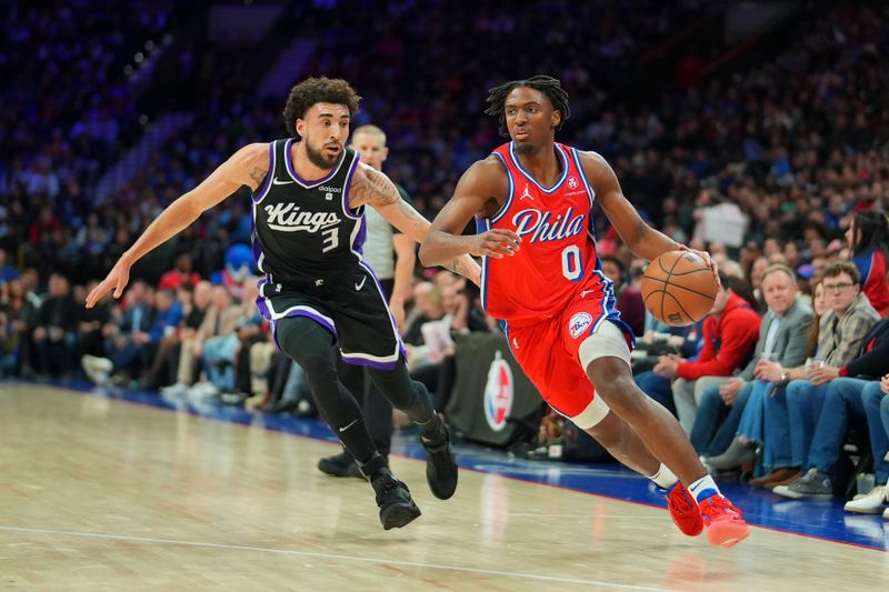 PHILADELPHIA, PENNSYLVANIA - JANUARY 12: Tyrese Maxey #0 of the Philadelphia 76ers dribbles the ball to the basket against Chris Duarte #3 of the Sacramento Kings in the first half at the Wells Fargo Center on January 12, 2024 in Philadelphia, Pennsylvania. NOTE TO USER: User expressly acknowledges and agrees that, by downloading and or using this photograph, User is consenting to the terms and conditions of the Getty Images License Agreement. (Photo by Mitchell Leff/Getty Images)