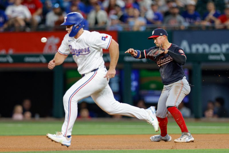 May 1, 2024; Arlington, Texas, USA; Washington Nationals second base Ildemaro Vargas (14) starts a double play during the fourth inning against the Texas Rangers at Globe Life Field. Mandatory Credit: Andrew Dieb-USA TODAY Sports