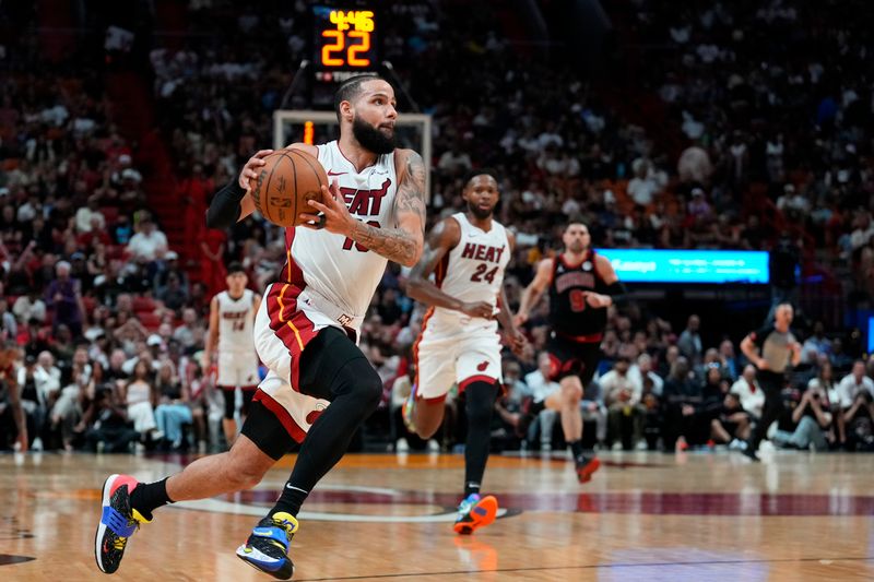 MIAMI, FLORIDA - APRIL 19: Caleb Martin #16 of the Miami Heat dribbles the ball up the court against the Chicago Bulls in the second quarter during the Play-In Tournament at Kaseya Center on April 19, 2024 in Miami, Florida. NOTE TO USER: User expressly acknowledges and agrees that, by downloading and or using this photograph, User is consenting to the terms and conditions of the Getty Images License Agreement. (Photo by Rich Storry/Getty Images)