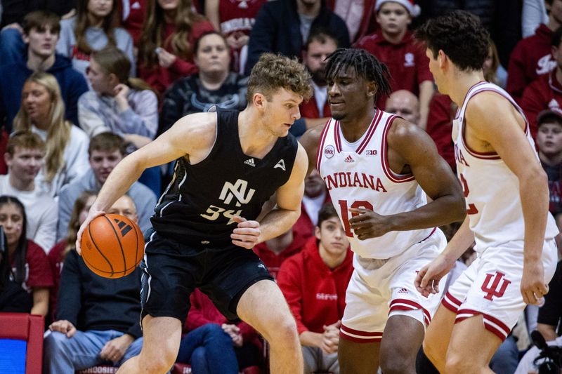 Dec 21, 2023; Bloomington, Indiana, USA; North Alabama Lions forward Dallas Howell (34) dribbles the ball while Indiana Hoosiers forward Kaleb Banks (10) defends in the first half at Simon Skjodt Assembly Hall. Mandatory Credit: Trevor Ruszkowski-USA TODAY Sports