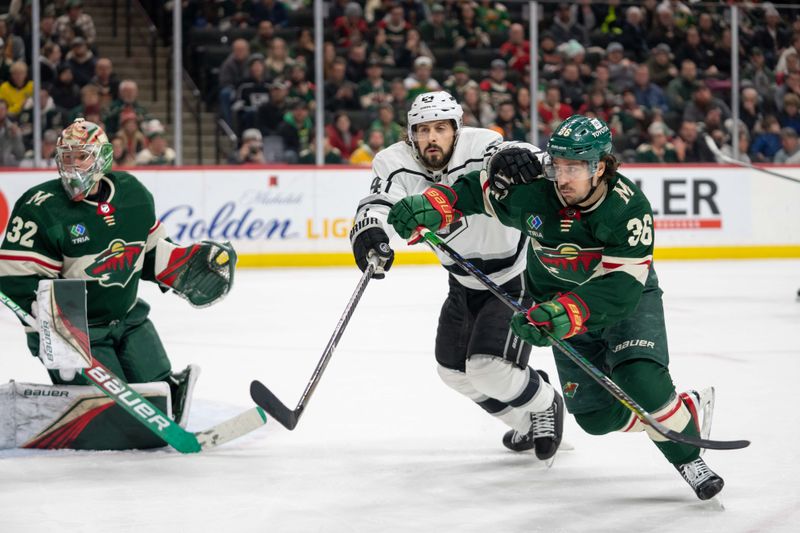 Feb 21, 2023; Saint Paul, Minnesota, USA; Minnesota Wild right wing Mats Zuccarello (36) and Los Angeles Kings center Phillip Danault (24) chase a rebound in the third period at Xcel Energy Center. Mandatory Credit: Matt Blewett-USA TODAY Sports