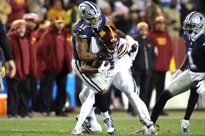 Dallas Cowboys linebacker Micah Parsons (11) takes down Washington Commanders wide receiver Terry McLaurin (17) during an NFL football game, Sunday, January 7, 2024 in Landover, Md. (AP Photo/Daniel Kucin Jr.)