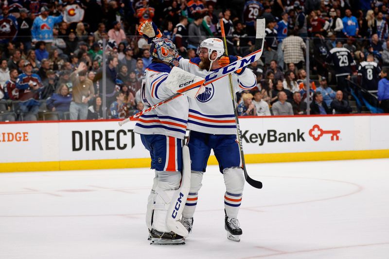 Apr 11, 2023; Denver, Colorado, USA; Edmonton Oilers defenseman Mattias Ekholm (14) celebrates with goaltender Stuart Skinner (74) after the game against the Colorado Avalanche at Ball Arena. Mandatory Credit: Isaiah J. Downing-USA TODAY Sports