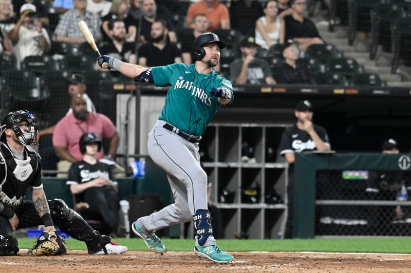 Aug 21, 2023; Chicago, Illinois, USA;  Seattle Mariners catcher Cal Raleigh (29) hits a three run home run against the Chicago White Sox during the eighth inning at Guaranteed Rate Field. Mandatory Credit: Matt Marton-USA TODAY Sports