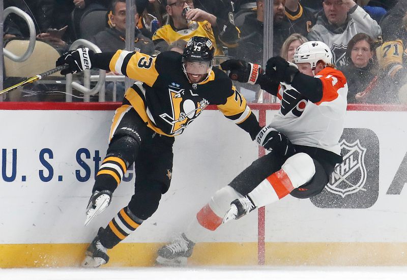 Feb 25, 2024; Pittsburgh, Pennsylvania, USA;  Pittsburgh Penguins defenseman Pierre-Olivier Joseph (73) checks Philadelphia Flyers right wing Owen Tippett (74) during the second period at PPG Paints Arena. Mandatory Credit: Charles LeClaire-USA TODAY Sports