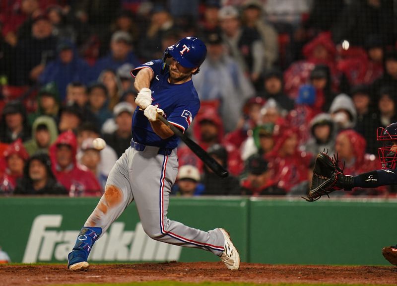 May 6, 2025; Boston, Massachusetts, USA; Texas Rangers first base Josh Smith (8) hits a single to drive in a run against the Boston Red Sox in the fourth inning at Fenway Park. Mandatory Credit: David Butler II-Imagn Images