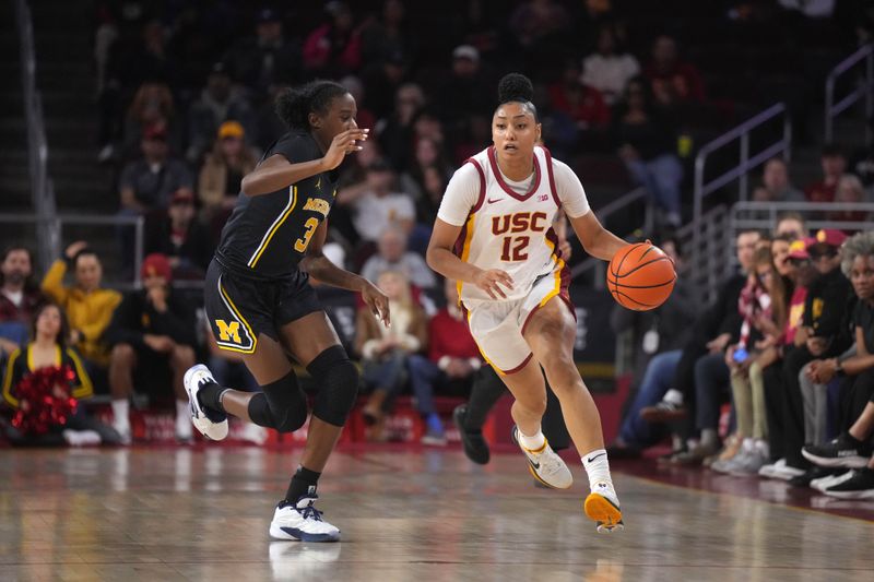 Dec 29, 2024; Los Angeles, California, USA; Southern California Trojans guard JuJu Watkins (12) dribbles the ball against Michigan Wolverines guard Te'Yala Delfosse (33) in the first half at Galen Center. Mandatory Credit: Kirby Lee-Imagn Images