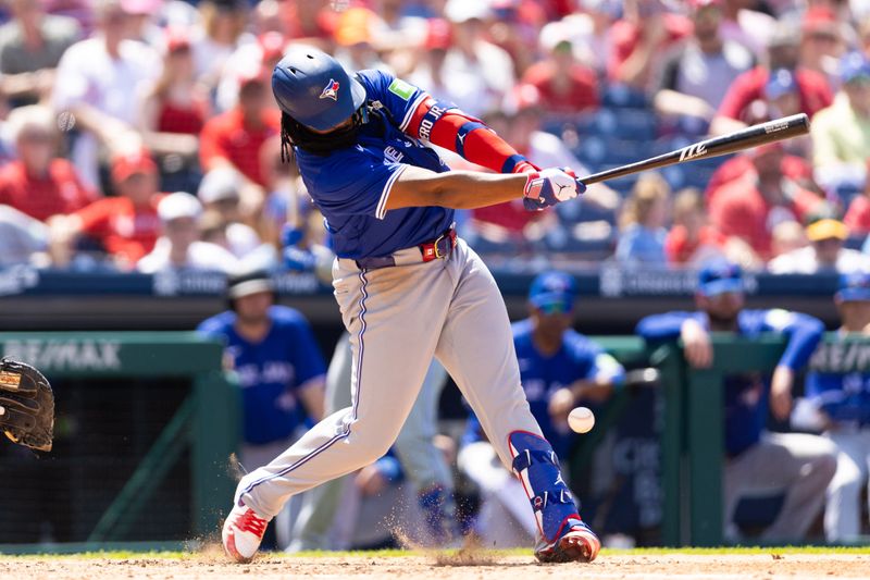 May 8, 2024; Philadelphia, Pennsylvania, USA; Toronto Blue Jays first base Vladimir Guerrero Jr. (27) hits an infield single during the sixth inning against the Philadelphia Phillies at Citizens Bank Park. Mandatory Credit: Bill Streicher-USA TODAY Sports