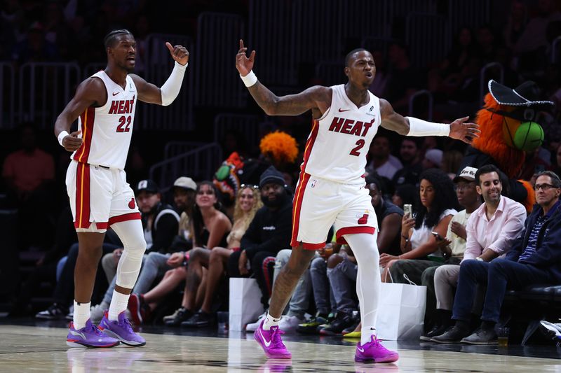 MIAMI, FLORIDA - OCTOBER 16: Jimmy Butler #22 and Terry Rozier #2 of the Miami Heat react against the Atlanta Hawks during the second quarter of a preseason game at Kaseya Center on October 16, 2024 in Miami, Florida. NOTE TO USER: User expressly acknowledges and agrees that, by downloading and or using this photograph, User is consenting to the terms and conditions of the Getty Images License Agreement. (Photo by Megan Briggs/Getty Images)