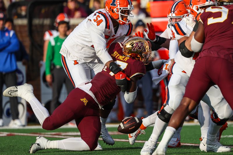 Nov 4, 2023; Minneapolis, Minnesota, USA; Minnesota Golden Gophers defensive lineman Jah Joyner (17) forces a fumble on Illinois Fighting Illini quarterback Luke Altmyer (9) during the second half at Huntington Bank Stadium. Mandatory Credit: Matt Krohn-USA TODAY Sports