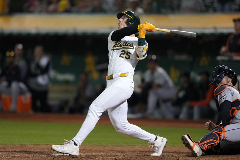 Sep 6, 2024; Oakland, California, USA; Oakland Athletics designated hitter Brent Rooker (25) hits an RBI sacrifice fly against the Detroit Tigers during the twelfth inning at Oakland-Alameda County Coliseum. Mandatory Credit: Darren Yamashita-Imagn Images