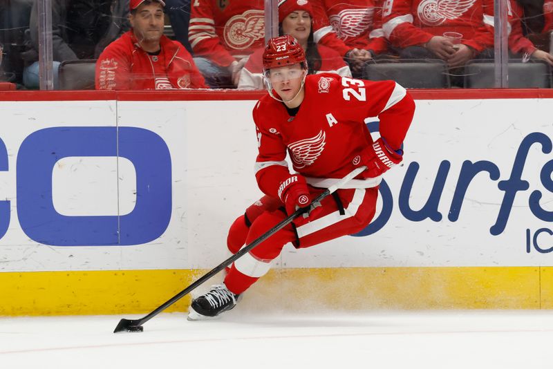 Jan 8, 2026; Detroit, Michigan, USA;  Detroit Red Wings left wing Lucas Raymond (23) skates with the puck in the second period against the Vancouver Canucks at Little Caesars Arena. Mandatory Credit: Rick Osentoski-Imagn Images