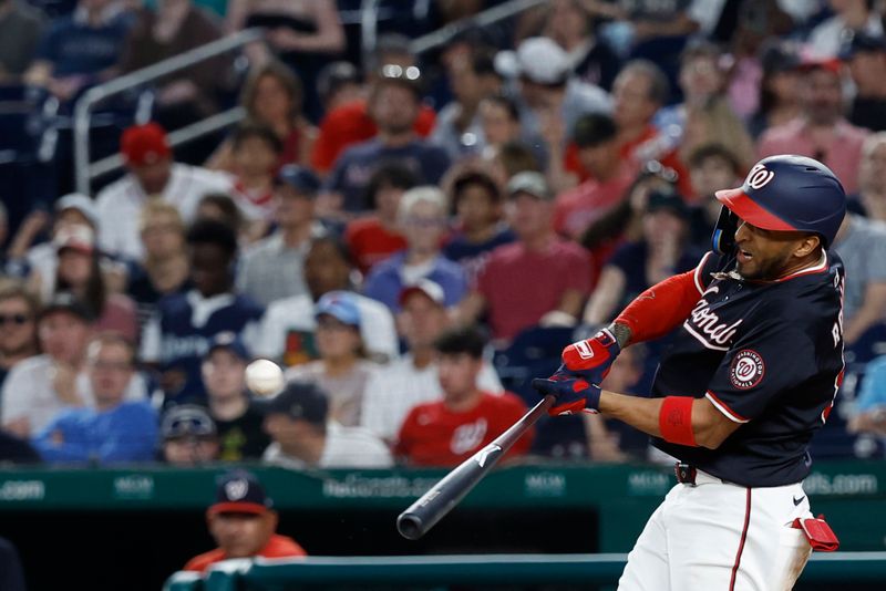 May 24, 2024; Washington, District of Columbia, USA; Washington Nationals outfielder Eddie Rosario (8) hits a solo home run against the Seattle Mariners during the eighth inning at Nationals Park. Mandatory Credit: Geoff Burke-USA TODAY Sports