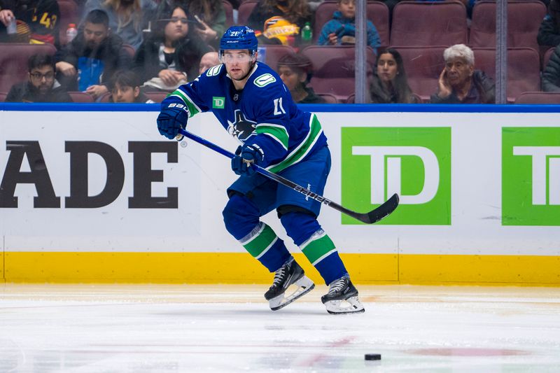 Oct 11, 2024; Vancouver, British Columbia, CAN; Vancouver Canucks forward Nils Hoglander (21) makes a pass against the Philadelphia Flyers during the second period at Rogers Arena. Mandatory Credit: Bob Frid-Imagn Images