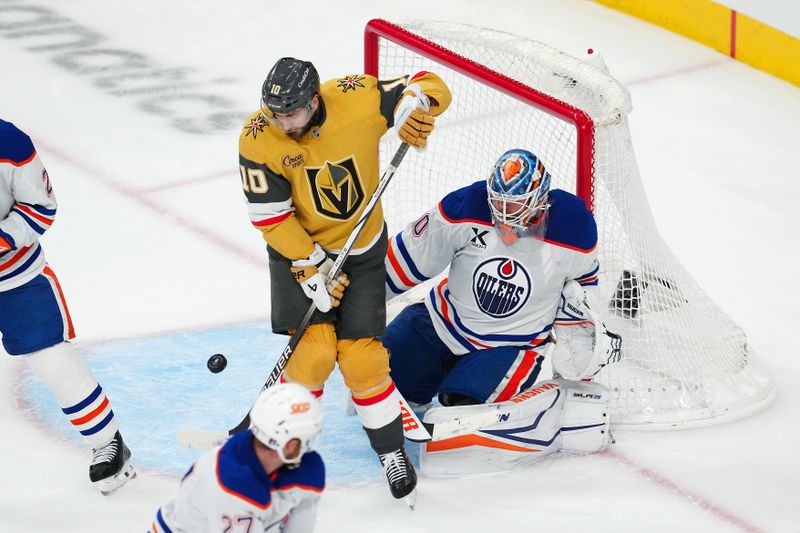 May 6, 2025; Las Vegas, Nevada, USA; Vegas Golden Knights center Nicolas Roy (10) attempts to deflect the puck towards Edmonton Oilers goaltender Calvin Pickard (30) during the third period of  game one of the second round of the 2025 Stanley Cup Playoffs at T-Mobile Arena. Mandatory Credit: Stephen R. Sylvanie-Imagn Images