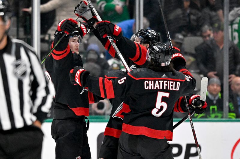 Jan 25, 2023; Dallas, Texas, USA; Carolina Hurricanes center Martin Necas (88) and defenseman Brett Pesce (22) and defenseman Jalen Chatfield (5) celebrate Necas scoring the game winning goal against the Dallas Stars during the overtime period at the American Airlines Center. Mandatory Credit: Jerome Miron-USA TODAY Sports