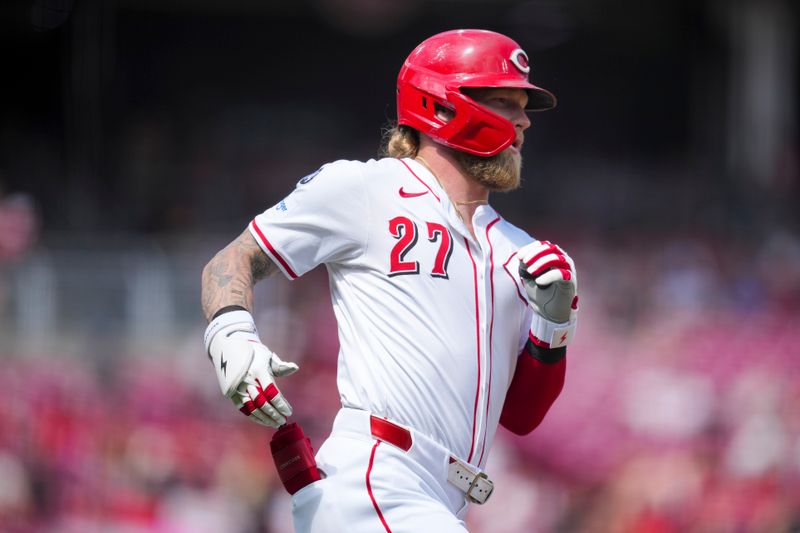 Jun 8, 2025; Cincinnati, Ohio, USA; Cincinnati Reds outfielder Jake Fraley (27) singles against the Arizona Diamondbacks in the seventh inning at Great American Ball Park. Mandatory Credit: Aaron Doster-Imagn Images