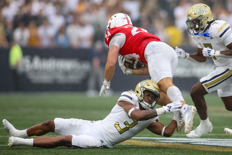 Sep 14, 2024; Atlanta, Georgia, USA; Georgia Tech Yellow Jackets defensive back Ahmari Harvey (3) tackles Virginia Military Institute Keydets running back Hunter Rice (24) in the second quarter at Bobby Dodd Stadium at Hyundai Field. Mandatory Credit: Brett Davis-Imagn Images