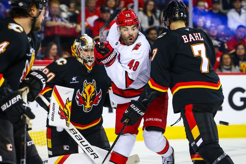 Oct 24, 2024; Calgary, Alberta, CAN; Carolina Hurricanes left wing Jordan Martinook (48) screens in front of Calgary Flames goaltender Dan Vladar (80) during the first period at Scotiabank Saddledome. Mandatory Credit: Sergei Belski-Imagn Images