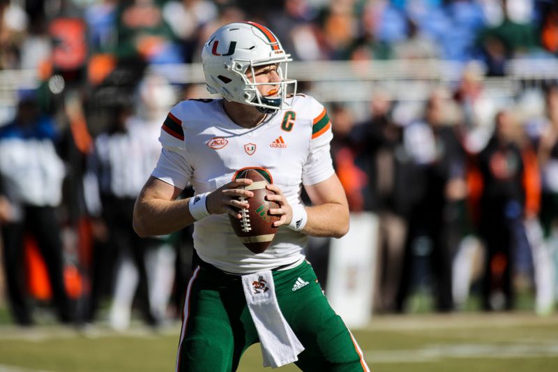 Nov 27, 2021; Durham, North Carolina, USA; Miami Hurricanes quarterback Tyler Van Dyke (9) with the ball during the first half of the game against the Miami Hurricanes at Wallace Wade Stadium. at Wallace Wade Stadium. Mandatory Credit: Jaylynn Nash-USA TODAY Sports