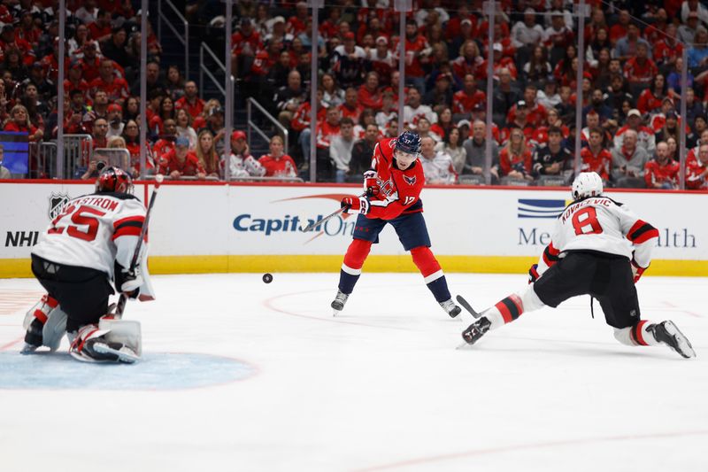 Oct 12, 2024; Washington, District of Columbia, USA; Washington Capitals center Dylan Strome (17) shoots the puck on New Jersey Devils goaltender Jacob Markstrom (25) as New Jersey Devils defenseman Johnathan Kovacevic (8) defends in the third period at Capital One Arena. Mandatory Credit: Geoff Burke-Imagn Images