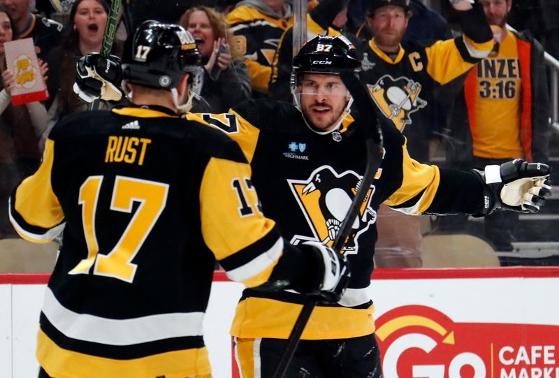 Apr 15, 2024; Pittsburgh, Pennsylvania, USA;  Pittsburgh Penguins right wing Bryan Rust (17) congratulates center Sidney Crosby (87) on his goal against the Nashville Predators during the first period at PPG Paints Arena. Mandatory Credit: Charles LeClaire-USA TODAY Sports