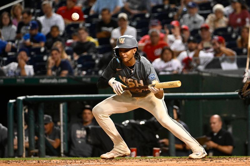 Sep 9, 2023; Washington, District of Columbia, USA; Washington Nationals shortstop CJ Abrams (5) hits a bunt single against the Los Angeles Dodgers during the fifth inning at Nationals Park. Mandatory Credit: Brad Mills-USA TODAY Sports