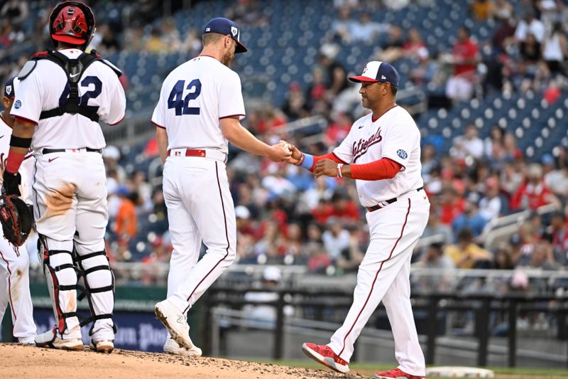 Apr 15, 2023; Washington, District of Columbia, USA; Washington Nationals starting pitcher Chad Kuhl (26) is removed from the game by manager Dave Martinez (4) during the fifth inning at Nationals Park. Mandatory Credit: Brad Mills-USA TODAY Sports