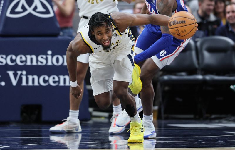 INDIANAPOLIS, INDIANA - JANUARY 25: Aaron Nesmith #23 of the Indiana Pacers reaches for a loose ball against the Philadelphia 76ers during the second half of the game at Gainbridge Fieldhouse on January 25, 2024 in Indianapolis, Indiana.    NOTE TO USER: User expressly acknowledges and agrees that, by downloading and or using this photograph, User is consenting to the terms and conditions of the Getty Images License Agreement.  (Photo by Andy Lyons/Getty Images)