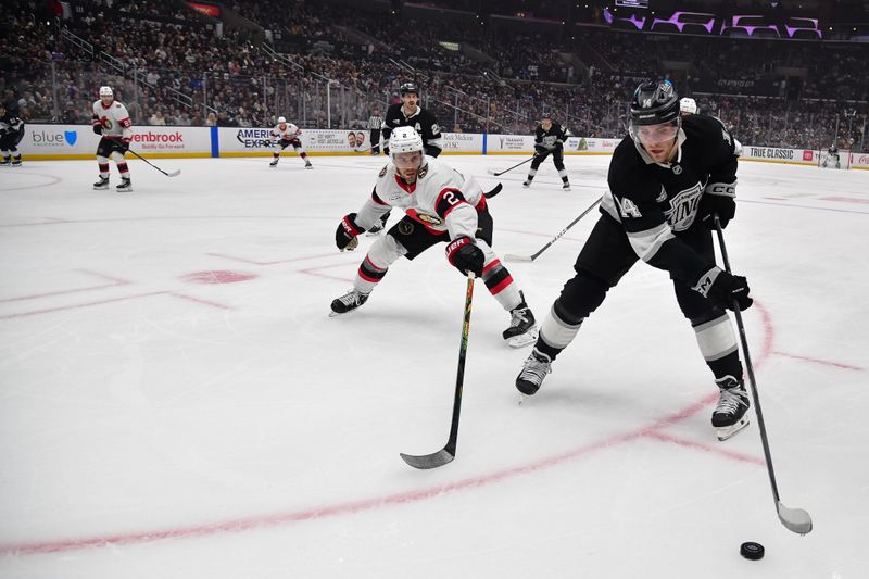 Nov 24, 2025; Los Angeles, California, USA; Los Angeles Kings right wing Alex Laferriere (14) moves the puck against Ottawa Senators defenseman Artem Zub (2) during the second period at Crypto.com Arena. Mandatory Credit: Gary A. Vasquez-Imagn Images