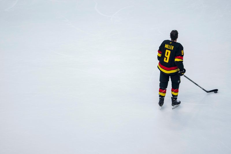 Jan 21, 2025; Vancouver, British Columbia, CAN; Vancouver Canucks forward J.T. Miller (9) handles the puck during warm up prior to a game against the Buffalo Sabres at Rogers Arena. Mandatory Credit: Bob Frid-Imagn Images