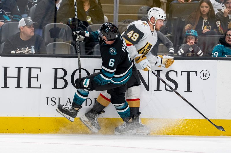 Feb 19, 2024; San Jose, California, USA; San Jose Sharks defenseman Ty Emberson (6) and Vegas Golden Knights center Ivan Barbashev (49) battle for the puck during the first period at SAP Center at San Jose. Mandatory Credit: Neville E. Guard-USA TODAY Sports