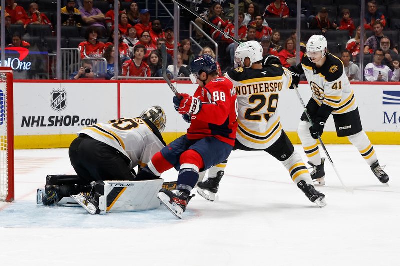 Oct 5, 2024; Washington, District of Columbia, USA; Washington Capitals left wing Andrew Mangiapane (88) and Boston Bruins defenseman Parker Wotherspoon (29) collide into Bruins goaltender Brandon Bussi (30) in the third period at Capital One Arena. Mandatory Credit: Geoff Burke-Imagn Images