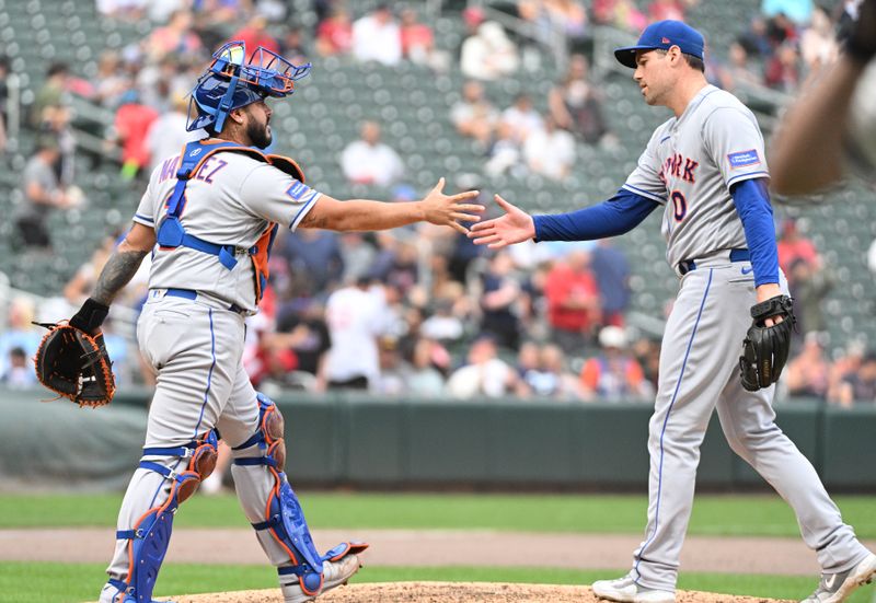 Sep 10, 2023; Minneapolis, Minnesota, USA; New York Mets catcher Omar Narvaez (2) and New York Mets relief pitcher Adam Ottavino (0) celebrate a 2-0 win over the Minnesota Twins at Target Field. Mandatory Credit: Michael McLoone-USA TODAY Sports