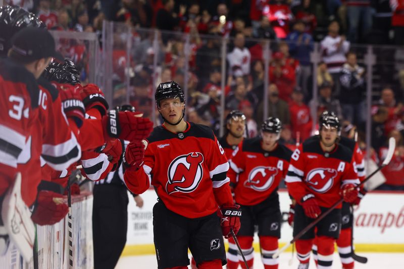 Nov 21, 2024; Newark, New Jersey, USA; New Jersey Devils left wing Jesper Bratt (63) celebrates his goal against the Carolina Hurricanes during the first period at Prudential Center. Mandatory Credit: Ed Mulholland-Imagn Images