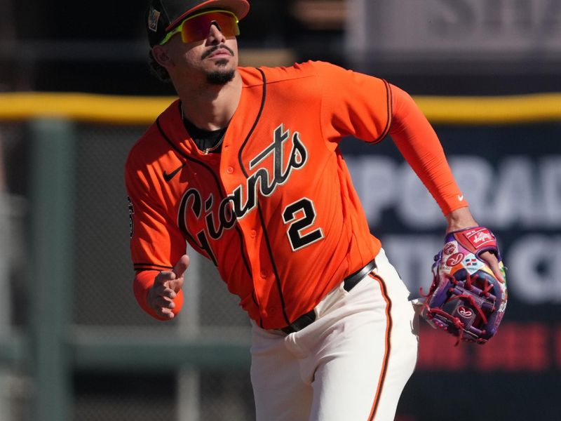 Feb 22, 2026; Scottsdale, Arizona, USA; San Francisco Giants shortstop Willy Adames (2) looks for the ball against the Chicago Cubs in the fourth inning at Scottsdale Stadium. Mandatory Credit: Rick Scuteri-Imagn Images