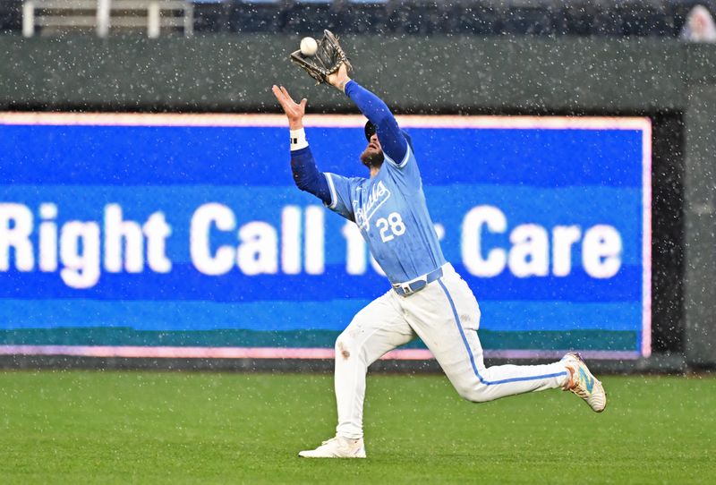 Apr 25, 2024; Kansas City, Missouri, USA;  Kansas City Royals center fielder Kyle Isbel (28) makes a running catch in the fifth inning against the Toronto Blue Jays at Kauffman Stadium. Mandatory Credit: Peter Aiken-USA TODAY Sports