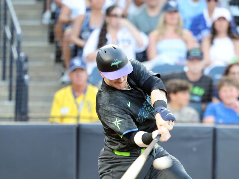 May 23, 2025; St. Petersburg, Florida, USA;  Tampa Bay Rays catcher Danny Jansen (19) doubles during the third inning against the Toronto Blue Jays at George M. Steinbrenner Field. Mandatory Credit: Kim Klement Neitzel-Imagn Images
