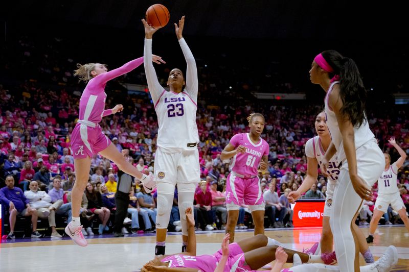 Feb 11, 2024; Baton Rouge, Louisiana, USA; LSU Lady Tigers center Aalyah Del Rosario (23) shoots but is charged with an offensive foul for knocking over Alabama Crimson Tide players during the first half at Pete Maravich Assembly Center. Mandatory Credit: Matthew Hinton-USA TODAY Sports