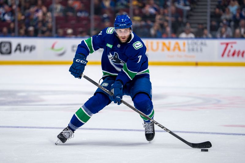 Oct 4, 2024; Vancouver, British Columbia, CAN; Vancouver Canucks defenseman Carson Soucy (7) handles the puck against the Edmonton Oilers during the first period at Rogers Arena. Mandatory Credit: Bob Frid-Imagn Images