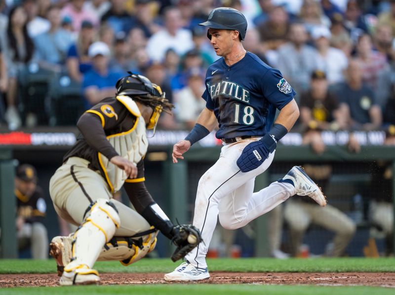 Aug 9, 2023; Seattle, Washington, USA; Seattle Mariners left fielder Cade Marlowe (18) scores a run against San Diego Padres catcher Luis Campusano (12) during the third inning at T-Mobile Park. Mandatory Credit: Stephen Brashear-USA TODAY Sports
