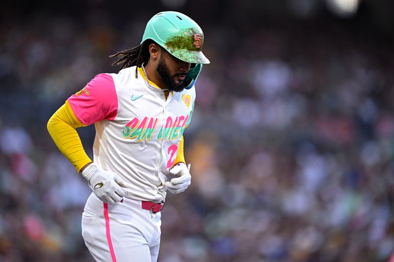 Jun 21, 2024; San Diego, California, USA; San Diego Padres right fielder Fernando Tatis Jr. (23) jogs to first base after being hit by a pitch during the third inning against the Milwaukee Brewers at Petco Park. Mandatory Credit: Orlando Ramirez-USA TODAY Sports