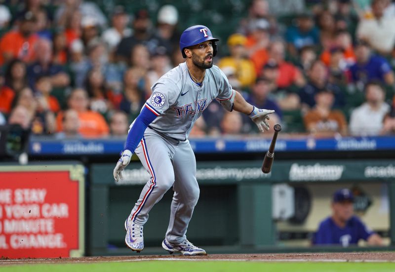 Jul 14, 2024; Houston, Texas, USA; Texas Rangers second baseman Marcus Semien (2) hits a single during the first inning against the Houston Astros at Minute Maid Park. Mandatory Credit: Troy Taormina-USA TODAY Sports