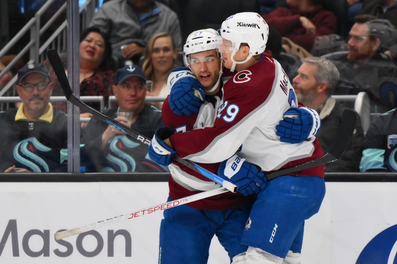 Nov 13, 2023; Seattle, Washington, USA; Colorado Avalanche left wing Jonathan Drouin (27) and center Nathan MacKinnon (29) celebrate after Drouin scored a goal against the Seattle Kraken during the third period at Climate Pledge Arena. Mandatory Credit: Steven Bisig-USA TODAY Sports