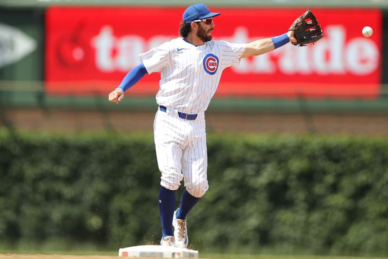 May 31, 2024; Chicago, Illinois, USA; Cincinnati Reds outfielder Spencer Steer (7) catches a ball at second base during the fourth inning against the Cincinnati Reds at Wrigley Field. Mandatory Credit: Melissa Tamez-USA TODAY Sports