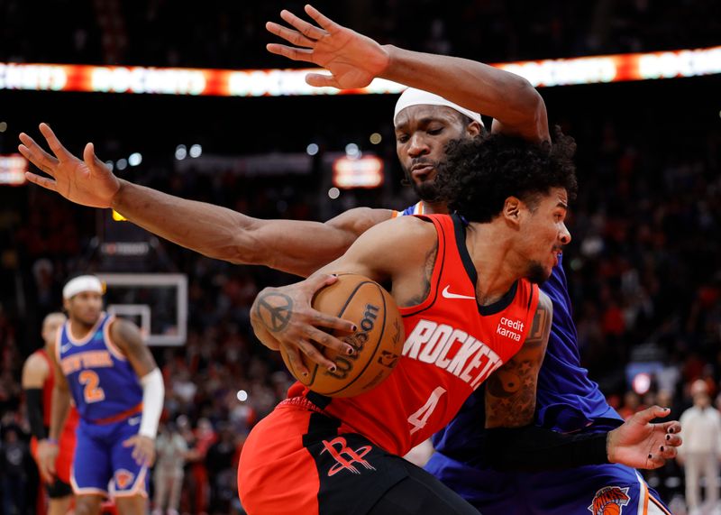 HOUSTON, TEXAS - FEBRUARY 12: Jalen Green #4 of the Houston Rockets drives past Precious Achiuwa #5 of the New York Knicks during the second half at Toyota Center on February 12, 2024 in Houston, Texas. NOTE TO USER: User expressly acknowledges and agrees that, by downloading and or using this photograph, User is consenting to the terms and conditions of the Getty Images License Agreement. (Photo by Carmen Mandato/Getty Images)