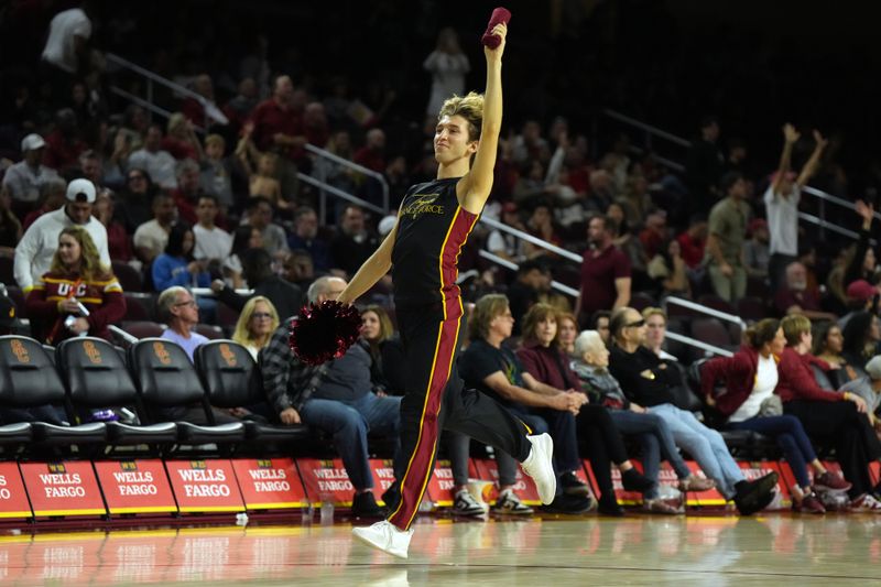 Jan 27, 2024; Los Angeles, California, USA; Southern California Trojans male dance force team cheerleader Hugo Miller gestures to the crowd in the second half against the UCLA Bruins at Galen Center. Mandatory Credit: Kirby Lee-USA TODAY Sports