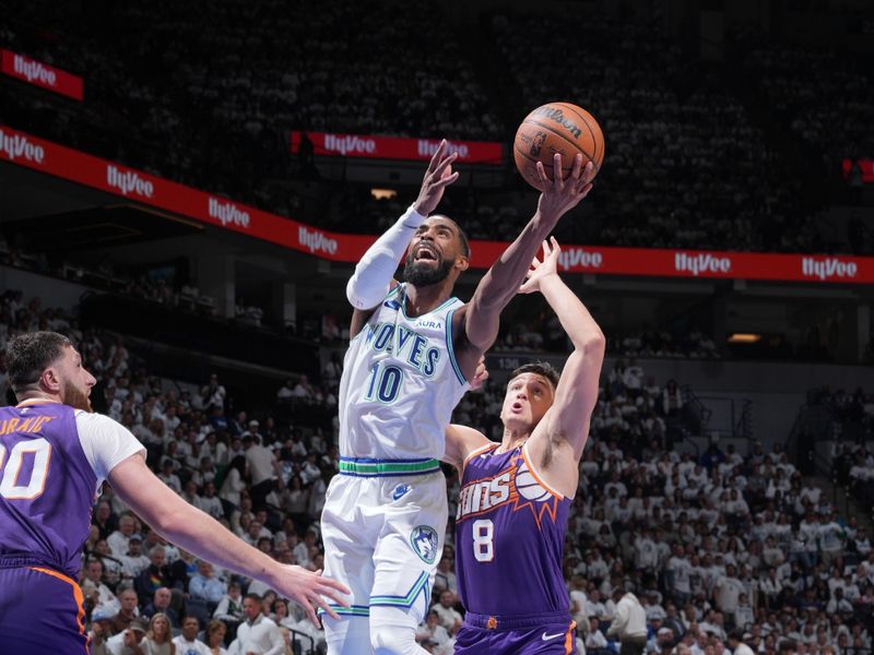 MINNEAPOLIS, MN -  APRIL 23: Mike Conley #10 of the Minnesota Timberwolves drives to the basket during the game against the Phoenix Suns during Round One Game Two of the 2024 NBA Playoffs on April 23, 2024 at Target Center in Minneapolis, Minnesota. NOTE TO USER: User expressly acknowledges and agrees that, by downloading and or using this Photograph, user is consenting to the terms and conditions of the Getty Images License Agreement. Mandatory Copyright Notice: Copyright 2024 NBAE (Photo by Jordan Johnson/NBAE via Getty Images)