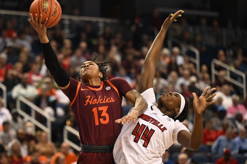 Mar 5, 2023; Greensboro, NC, USA; Virginia Tech Hokies forward Taylor Soule (13) drives past Louisville Cardinals forward Olivia Cochran (44) during the second half at Greensboro Coliseum. Mandatory Credit: William Howard-USA TODAY Sports