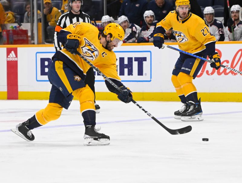 Jan 17, 2023; Nashville, Tennessee, USA;  Nashville Predators defenseman Roman Josi (59) takes a shot on goal against the Columbus Blue Jackets during the first period at Bridgestone Arena. Mandatory Credit: Steve Roberts-USA TODAY Sports